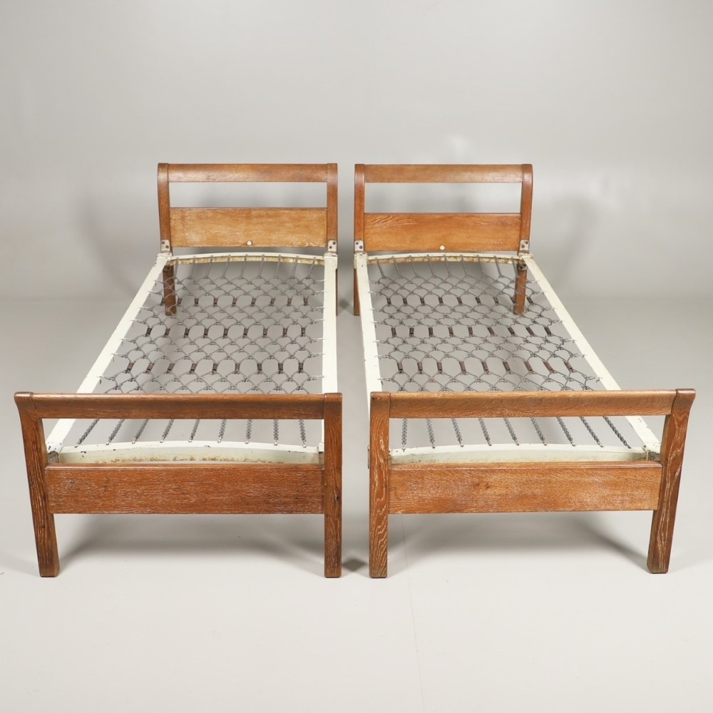A pair of Heals children's limed oak single beds circa 1930 