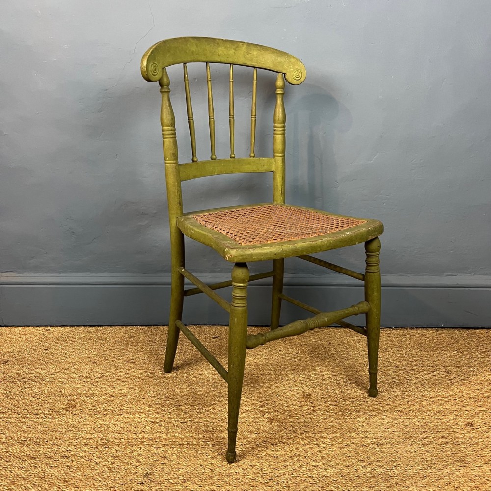 A mid 19th century green painted caned bedroom chair