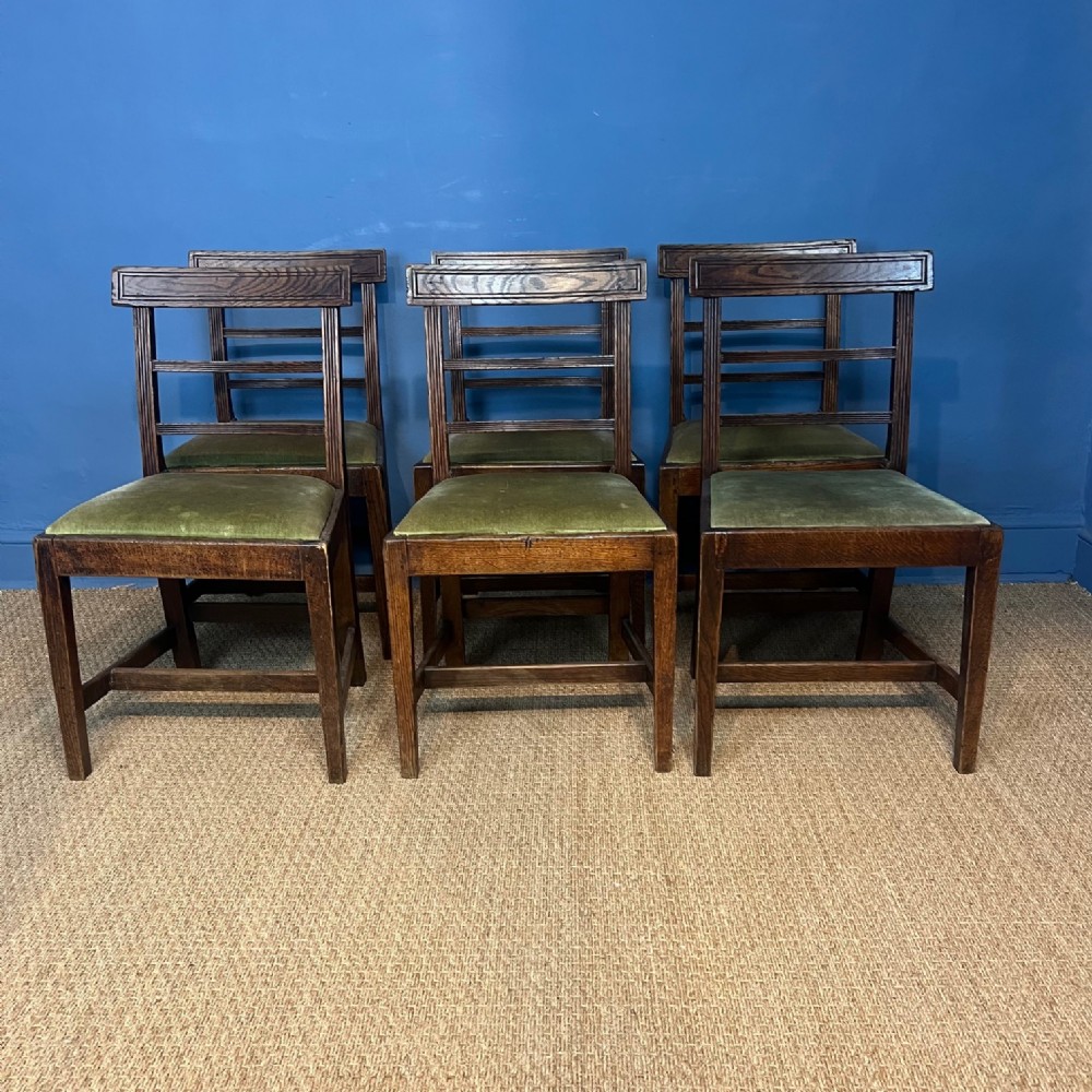 A set of six early 19th century elm provincial dining chairs in Sheraton style