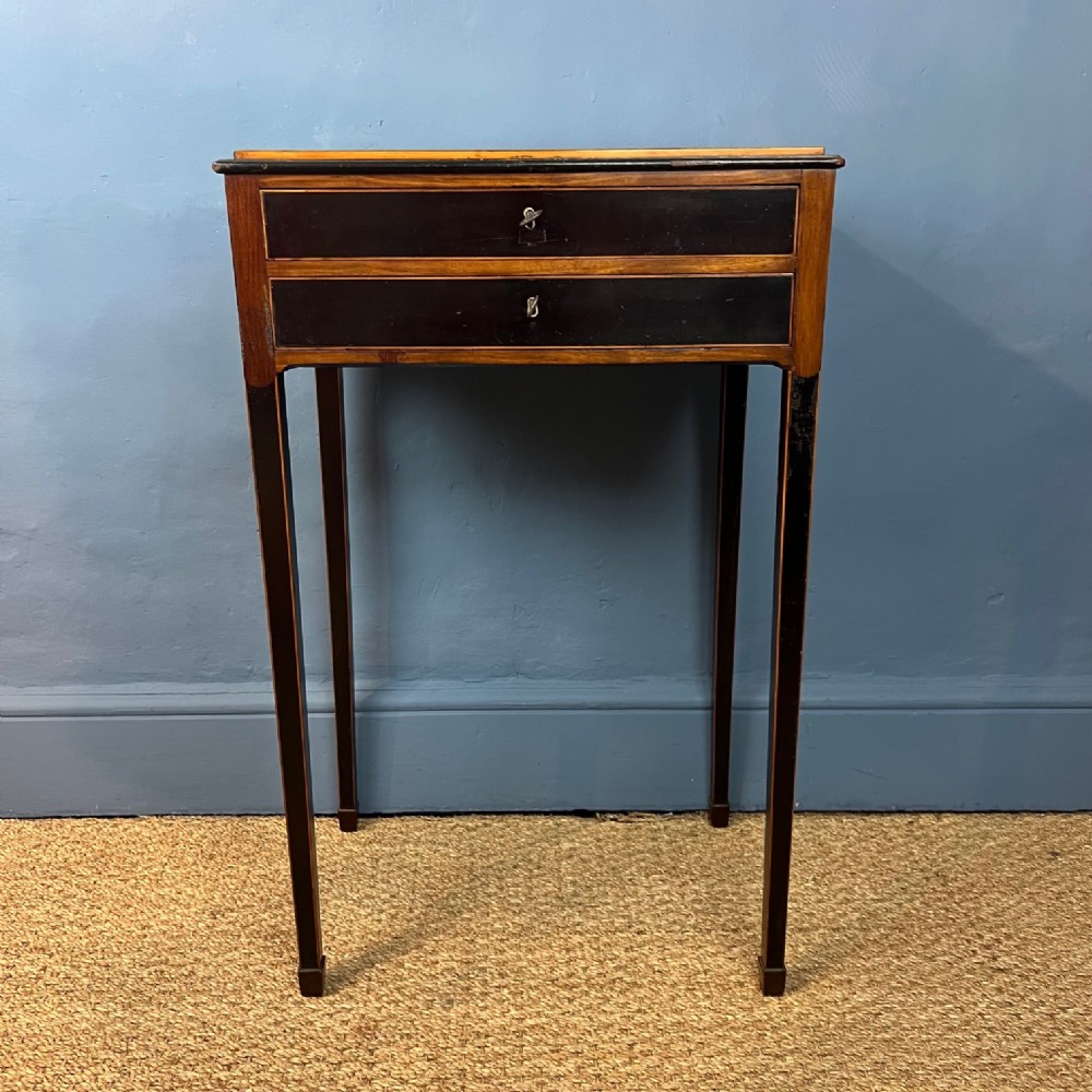 An unusual George III partridge wood mahogany and ebony two-drawer side table circa 1800