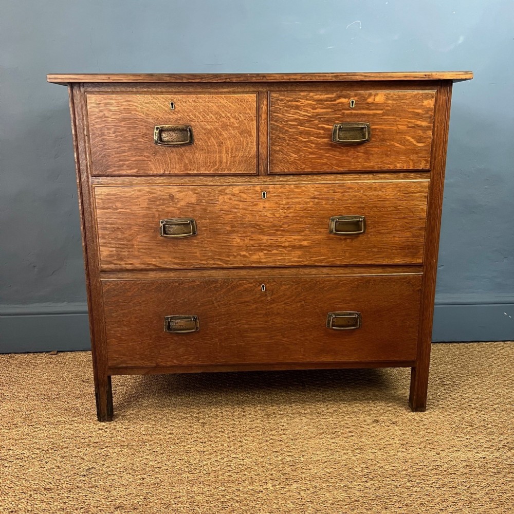 A rare small Heals model 402 oak chest of drawers designed in 1904 by Ambrose Heal.