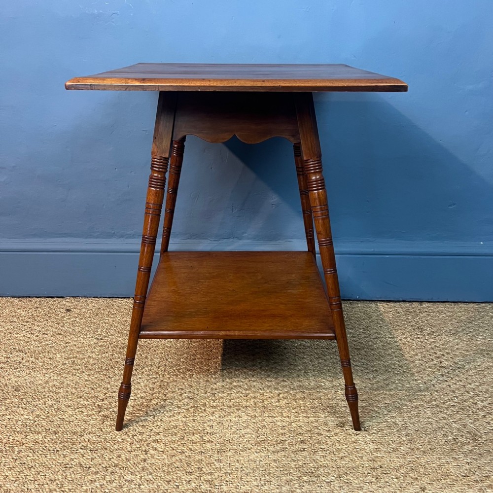 An Aesthetic Movement walnut 2 tier table circa 1880 .