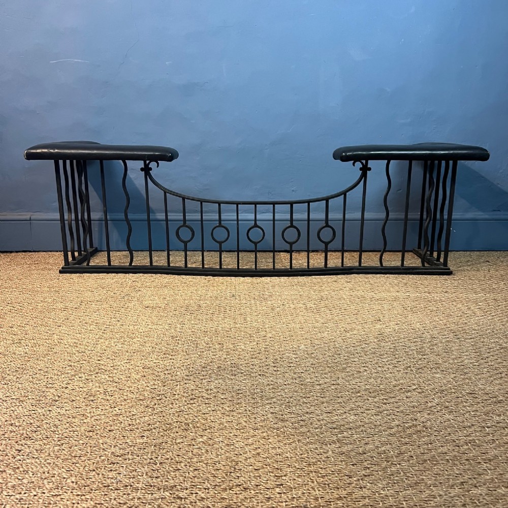 An Arts and Crafts wrought iron club fender circa 1910