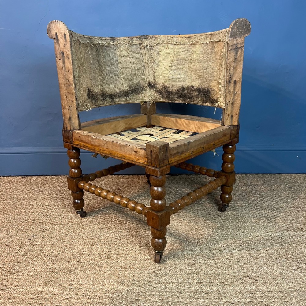 A late 19th c oak bobbin corner armchair 