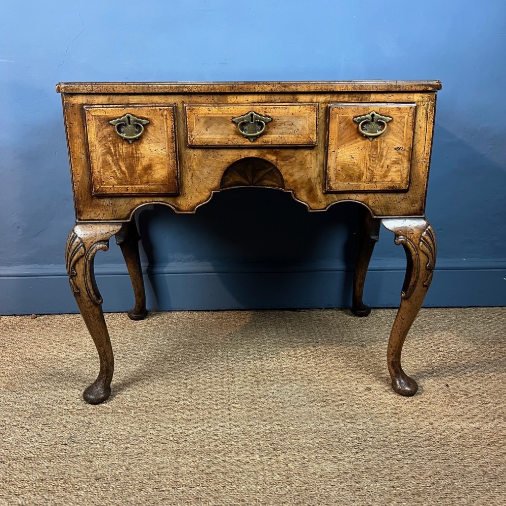 A Queen Anne style walnut lowboy circa 1910 
