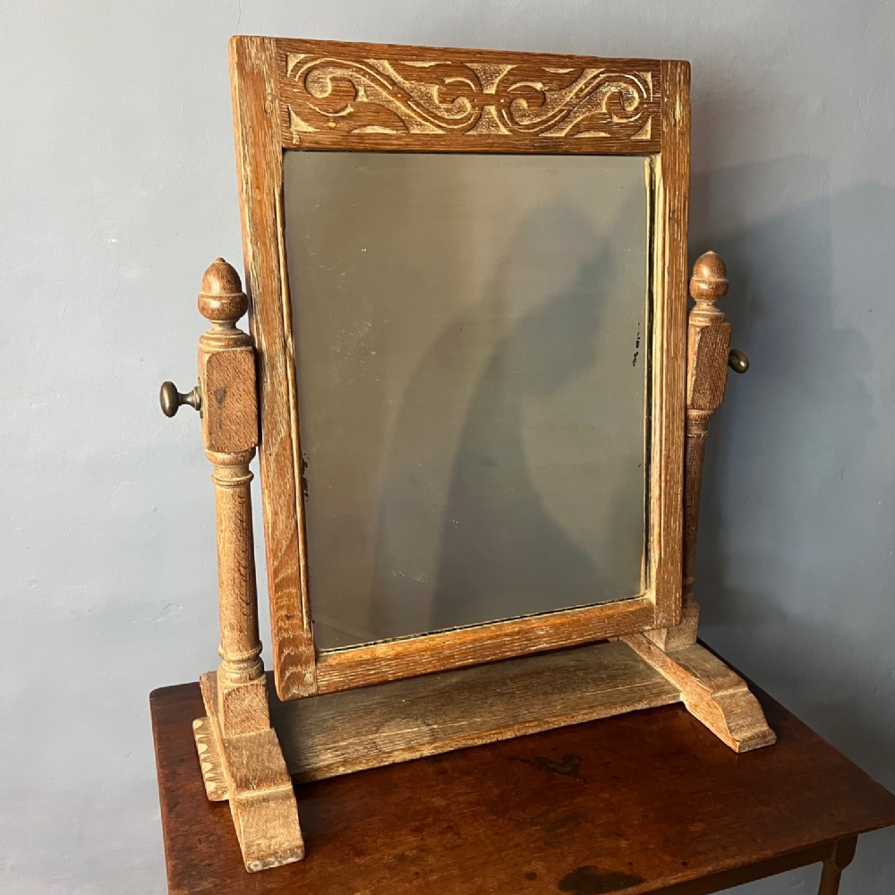 An Arts and Crafts oak toilet mirror circa 1930
