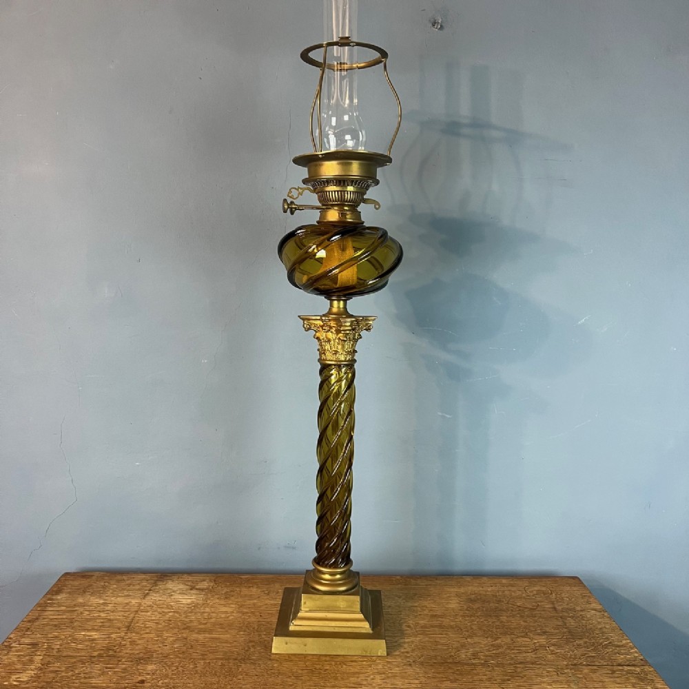 A very large Messenger and Co Amber coloured twist glass oil lamp circa 1880 on square brass column base 