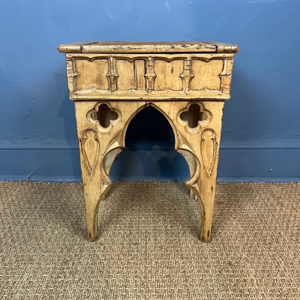 A late Regency Gothic pine Stool with carved tracery