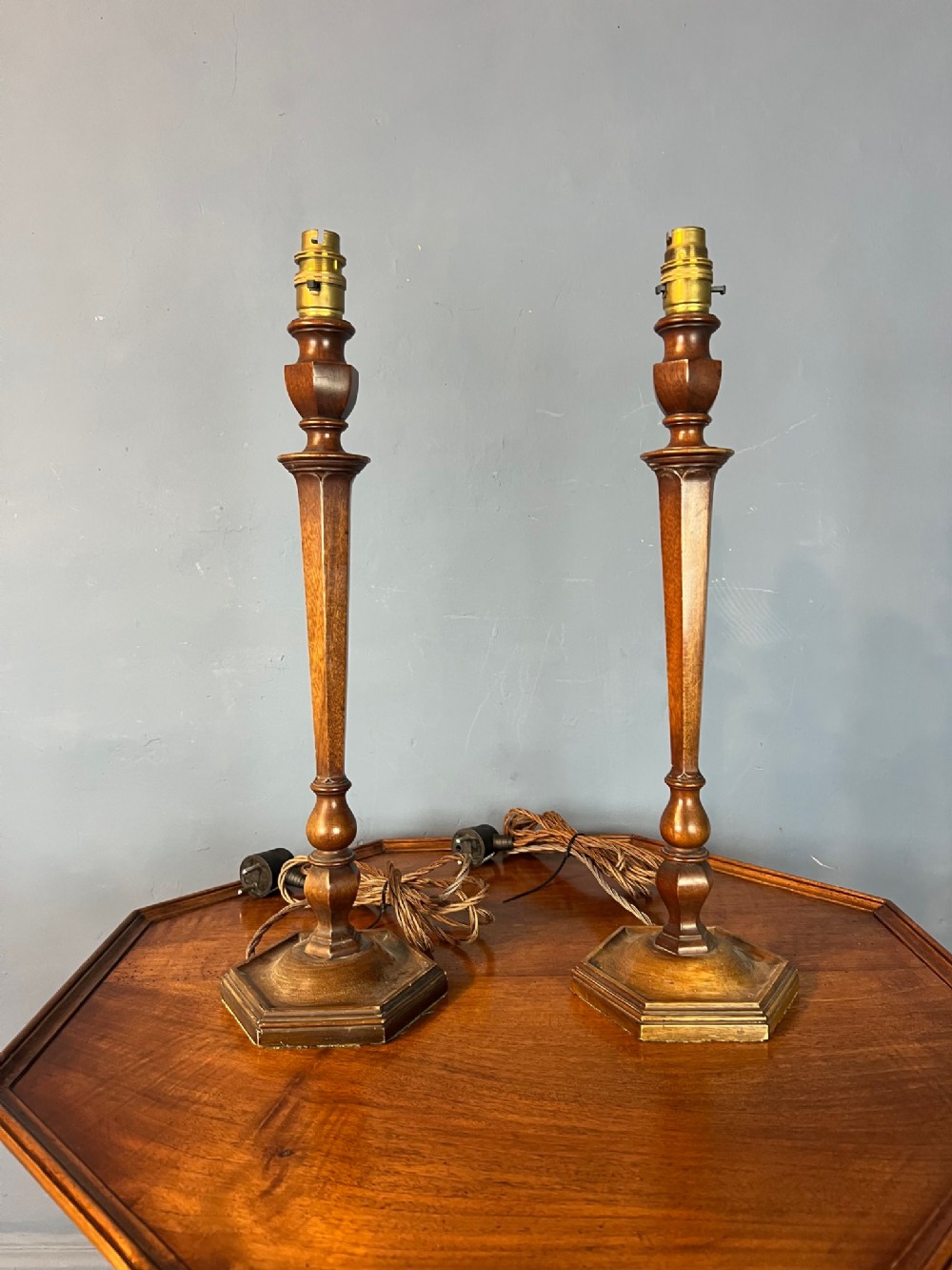 A pair of Edwardian walnut hexagonal table lamps circa 1910