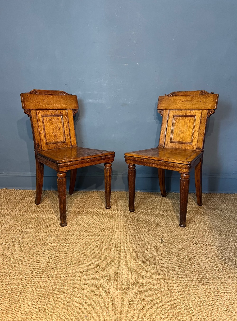 A pair of William IV oak hall chairs circa 1835 in the style of Sir Charles Barry