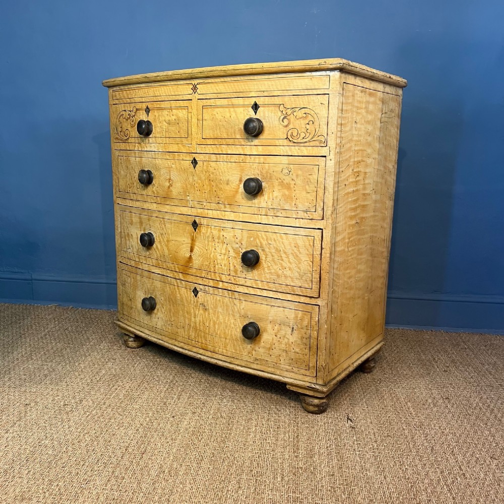 A late Regency painted bow front chest of drawers circa 1830