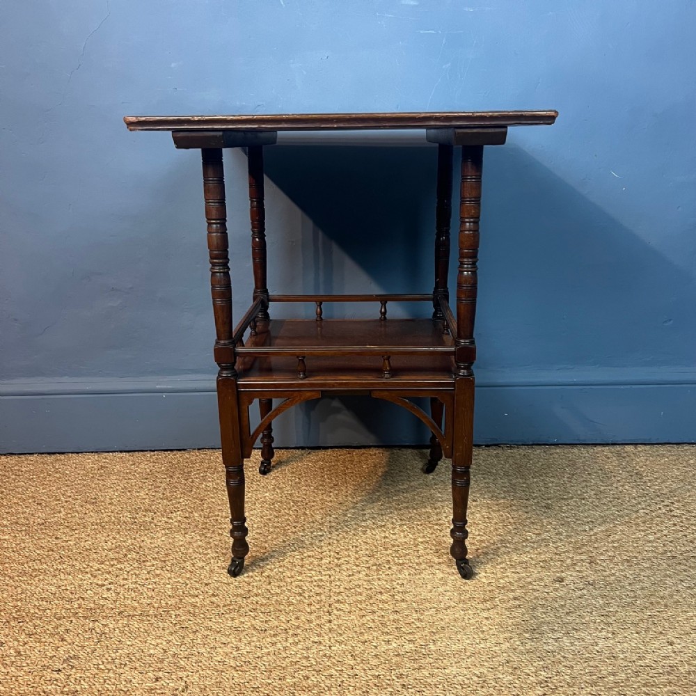 An Aesthetic Movement fiddle back mahogany 2 tier table after a design by E W Godwin circa 1880