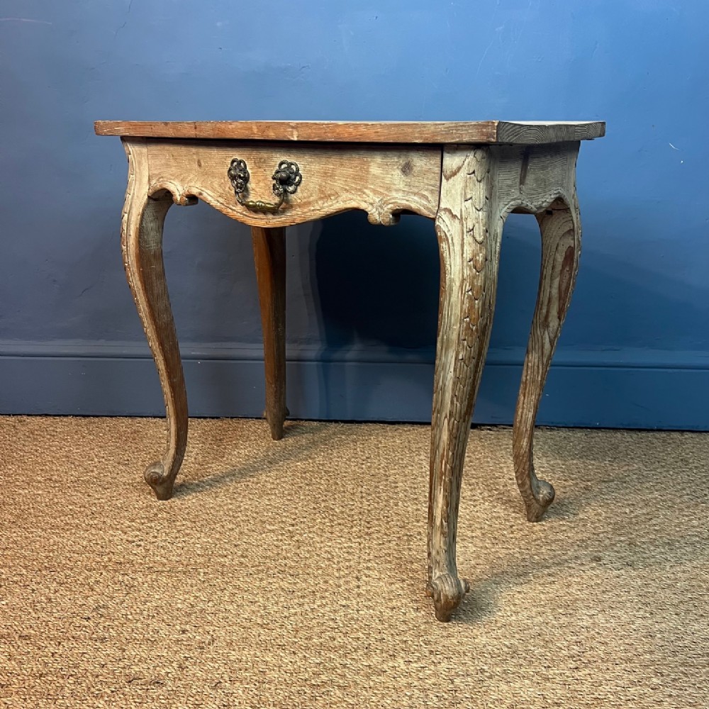 An Arts and Crafts limed oak serpentine side table circa 1920
