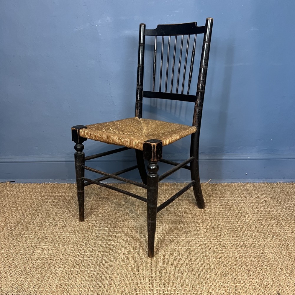 A William Morris ebonised beech Sussex Armchair to a design by Philip Webb circa 1880