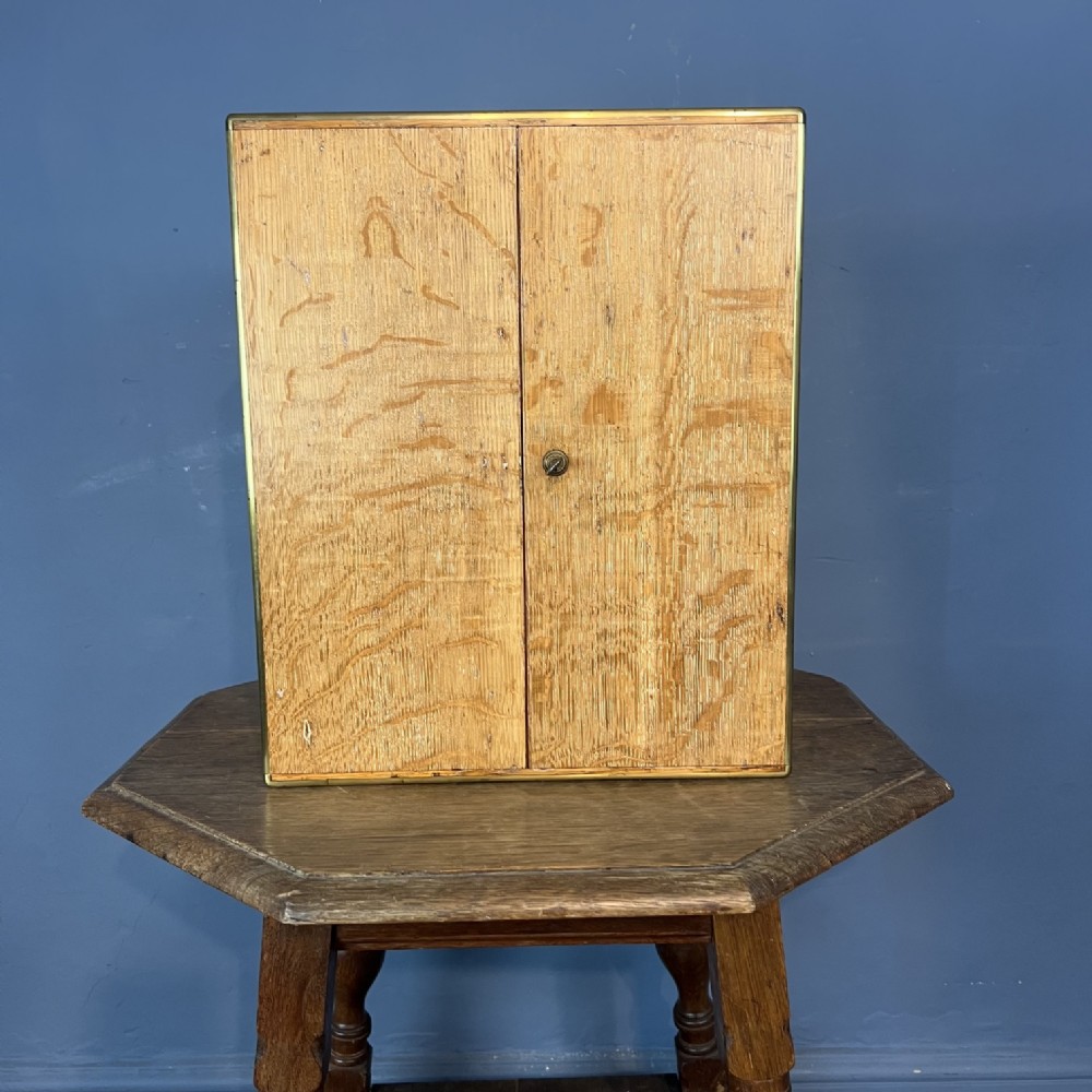 A mid 19th century Oak and Brass banded Collectors Cabinet circa 1860