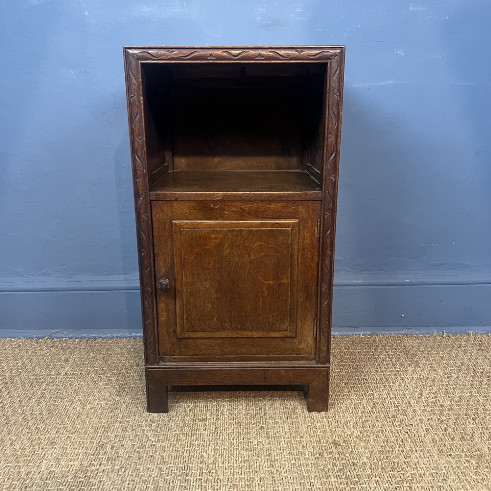 A Heal and Sons fumed oak bedside cabinet circa 1920