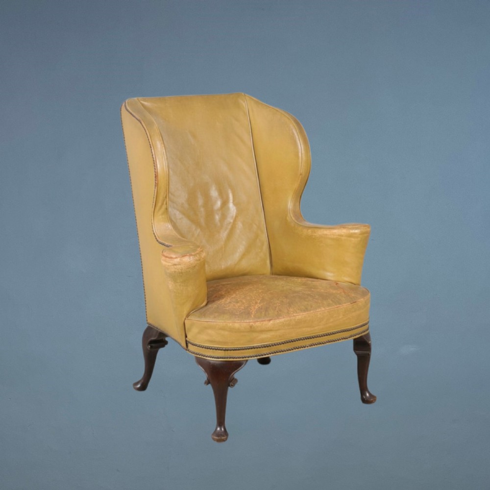 A late 19th c leather wing armchair circa 1900