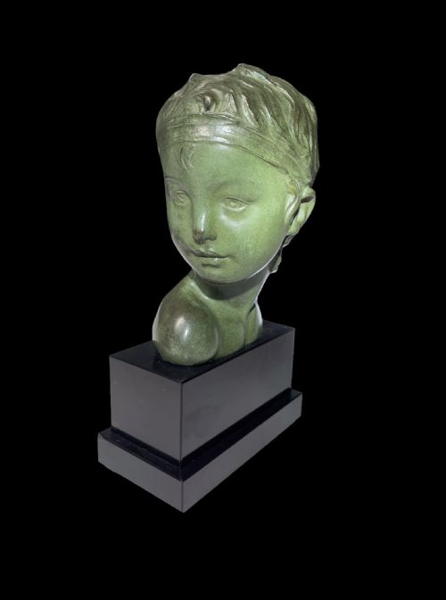 fig 3. An Art Deco patinated green bronze profile bust of a child, mounted on a polished black rectangular marble base.