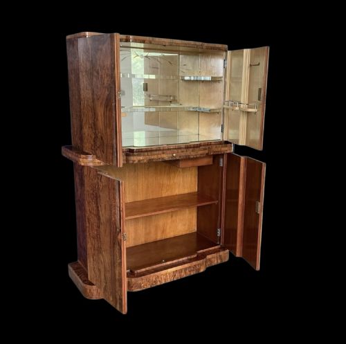 fig 1. A two-tiered Art Deco burr walnut cocktail cabinet featuring curved outer edges and two double-door compartments with a key tassel.