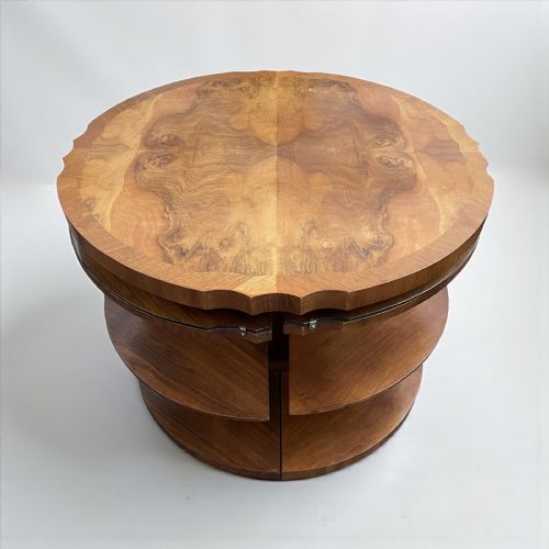 fig 1. An Art Deco walnut nest of tables featuring a central round coffee table surrounded by four matching curved quadrant side tables with glass tops.
