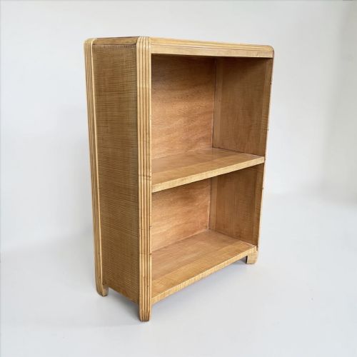 fig 1. A small Art Deco light wood open bookcase with two shelves and vertical reeded moulding along the outer edges.
