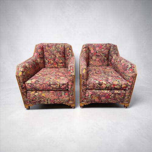 fig 1. A pair of Art Deco armchairs featuring geometric wooden side frames and multi-coloured patterned floral upholstery.