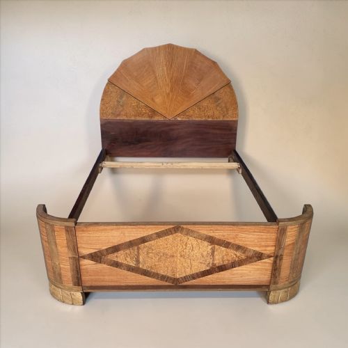 fig 1. An Art Deco double bedstead featuring a fan-shaped sunburst headboard panel and a diamond-patterned marquetry footboard crafted in figured walnut veneer.