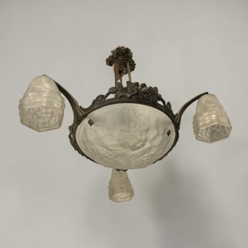 fig 1. An Art Deco ceiling light featuring a central moulded frosted glass bowl and matching outer shades supported by an ornate bronze mount.