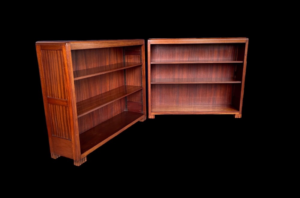A matching pair of low, open-front Art Deco wooden bookcases with three shelves and fluted side panels. View XI