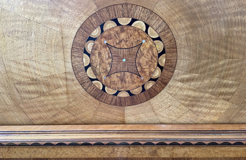 An Art Deco double headboard and footboard crafted with a sunburst timber veneer pattern and central circular marquetry motifs. View III