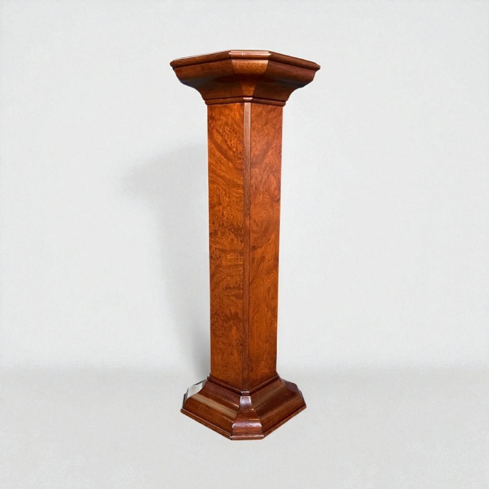 A tall octagonal Art Deco pedestal plant stand crafted from figured warm brown burr walnut wood.