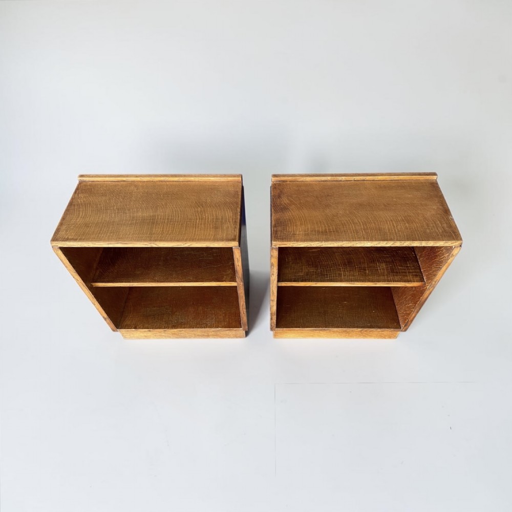 A matching pair of low, open oak bookcases featuring single fixed shelves and low gallery edges at the top. View II