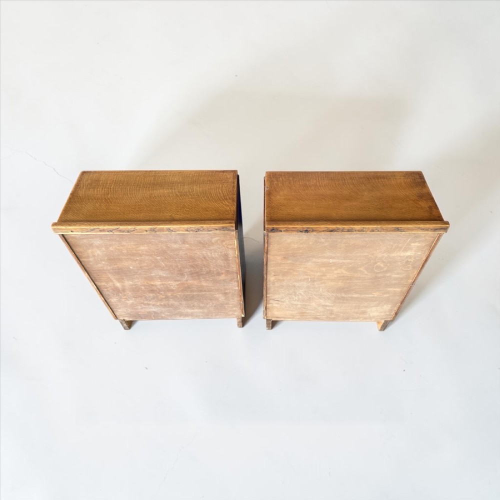 A matching pair of low, open oak bookcases featuring single fixed shelves and low gallery edges at the top. View III