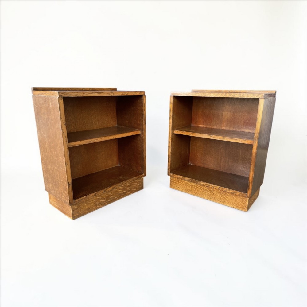 A matching pair of low, open oak bookcases featuring single fixed shelves and low gallery edges at the top. View IV