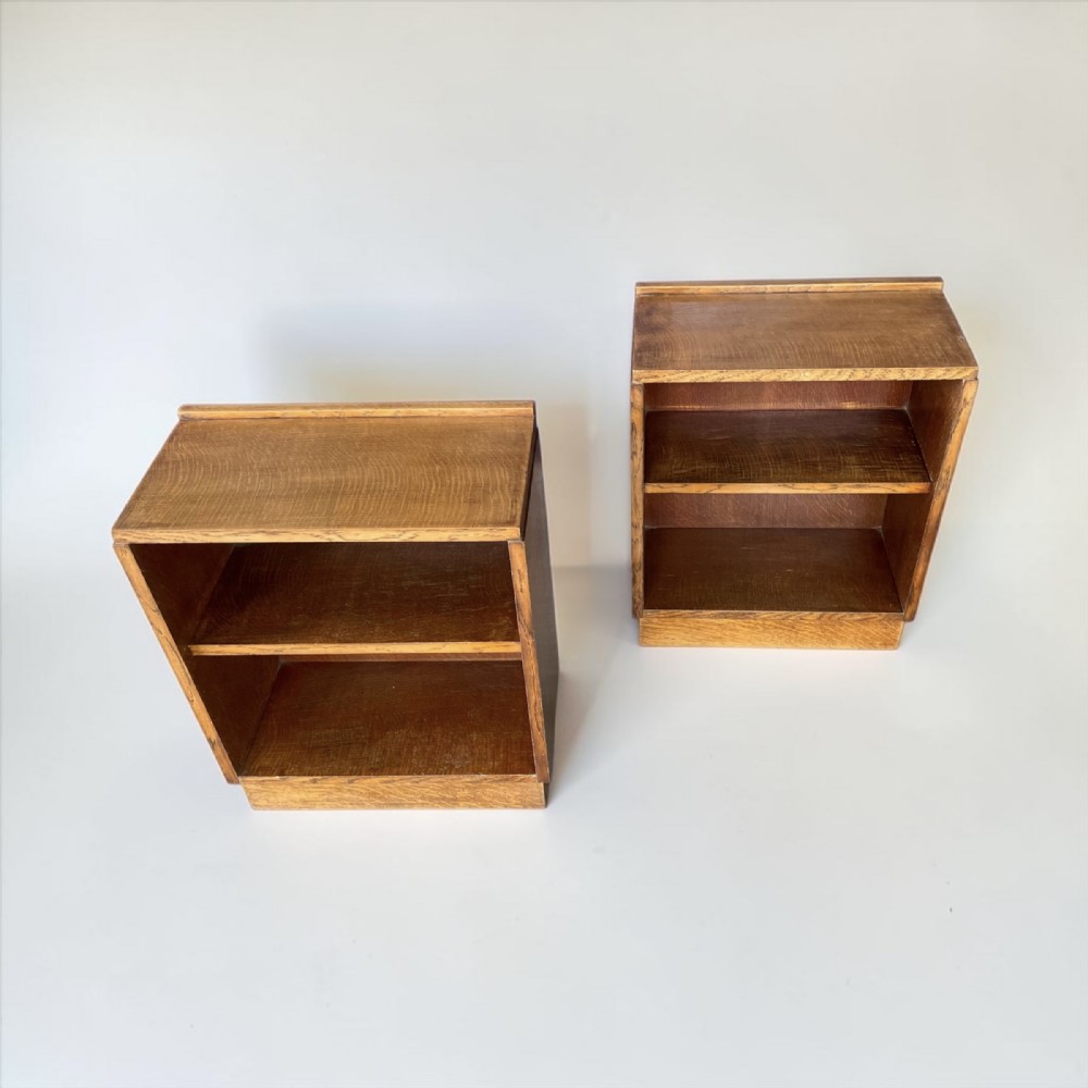A matching pair of low, open oak bookcases featuring single fixed shelves and low gallery edges at the top. View V