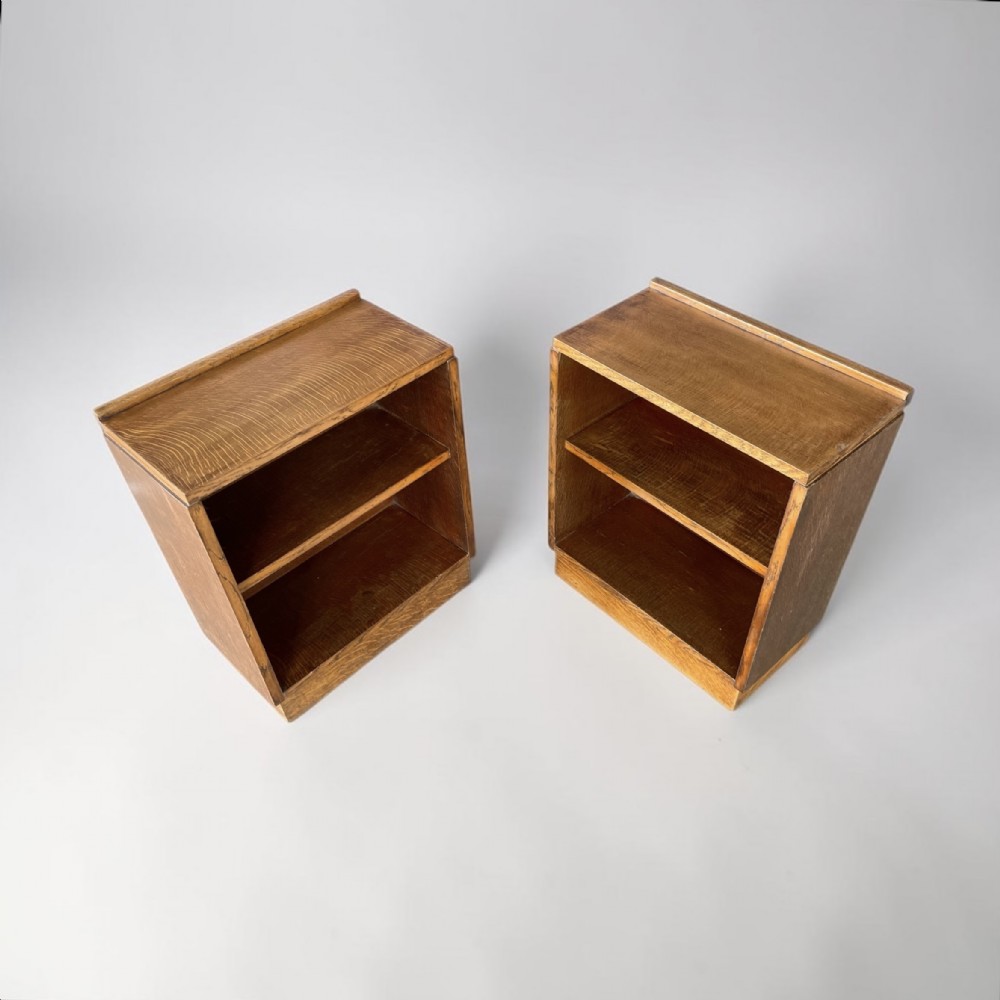 A matching pair of low, open oak bookcases featuring single fixed shelves and low gallery edges at the top. View VI