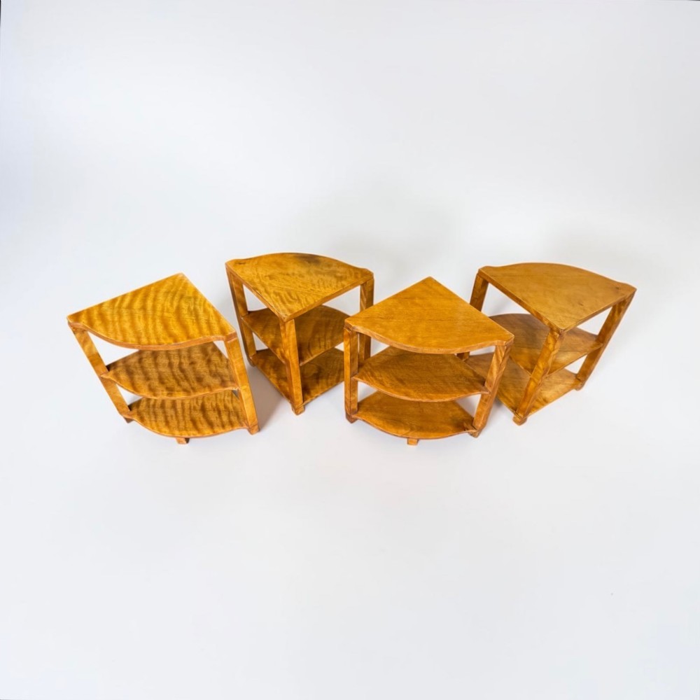 An Art Deco golden timber nest of five tables consisting of a central circular table encircled by four matching tiered wedge tables. View III