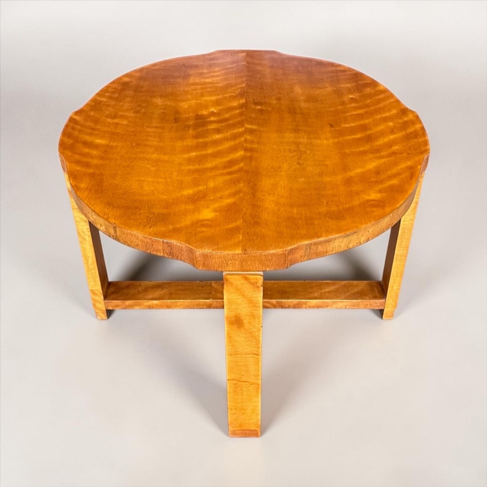 An Art Deco golden timber nest of five tables consisting of a central circular table encircled by four matching tiered wedge tables. View V