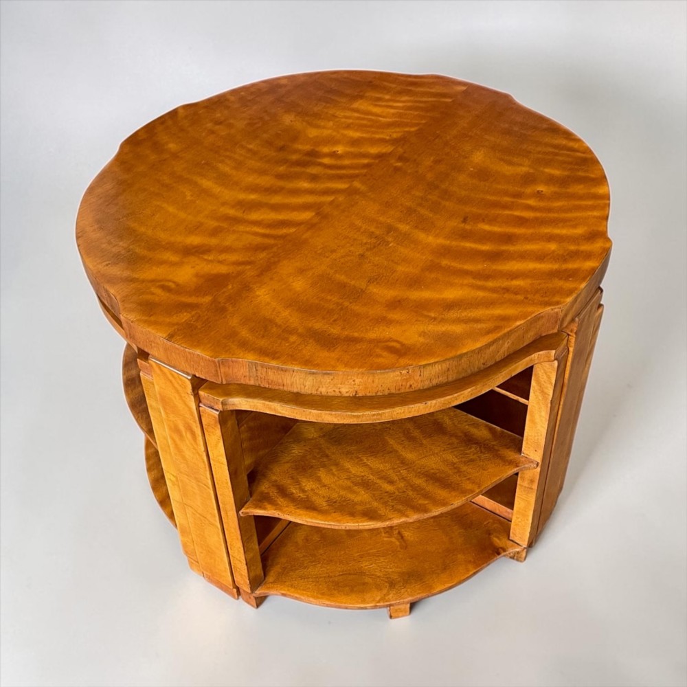 An Art Deco golden timber nest of five tables consisting of a central circular table encircled by four matching tiered wedge tables. View VIII