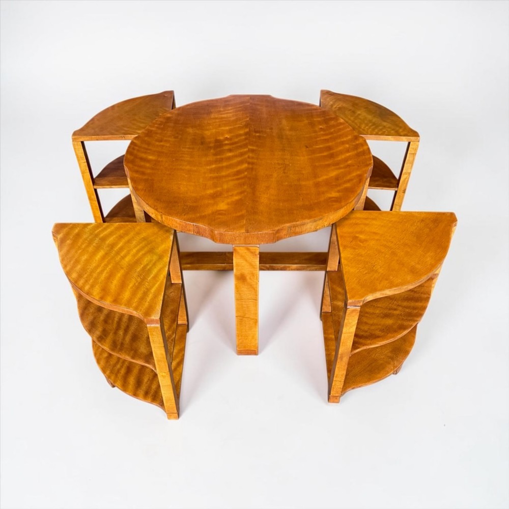 An Art Deco golden timber nest of five tables consisting of a central circular table encircled by four matching tiered wedge tables. View IX