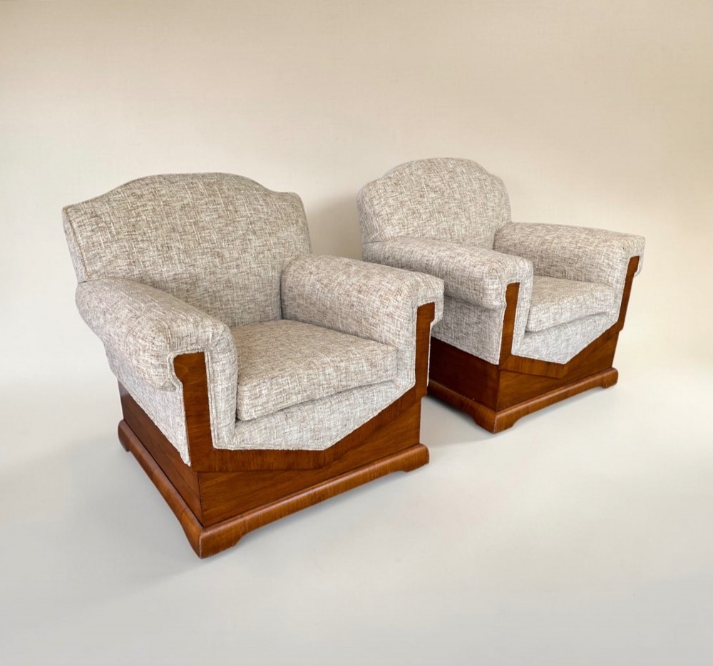 A pair of Art Deco lounge chairs featuring light beige textured upholstery and angular walnut bases. View II