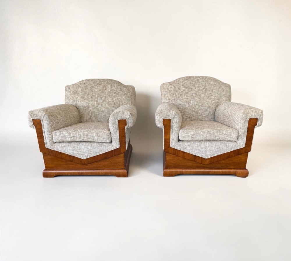 A pair of Art Deco lounge chairs featuring light beige textured upholstery and angular walnut bases. View III