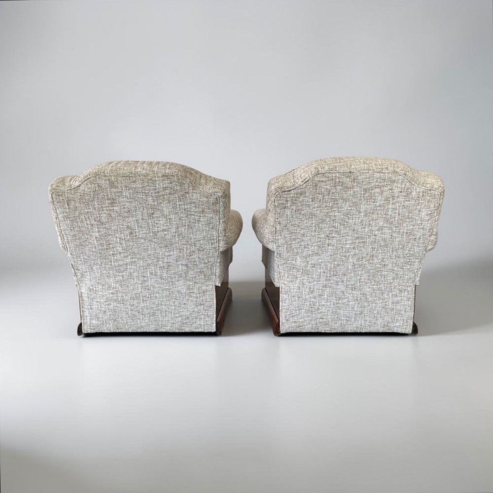 A pair of Art Deco lounge chairs featuring light beige textured upholstery and angular walnut bases. View VIII