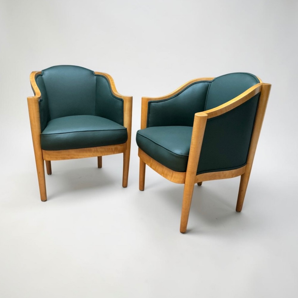 A pair of British Art Deco occasional chairs with curved light honey-toned timber frames and dark green leather upholstered seats and backrests. View III