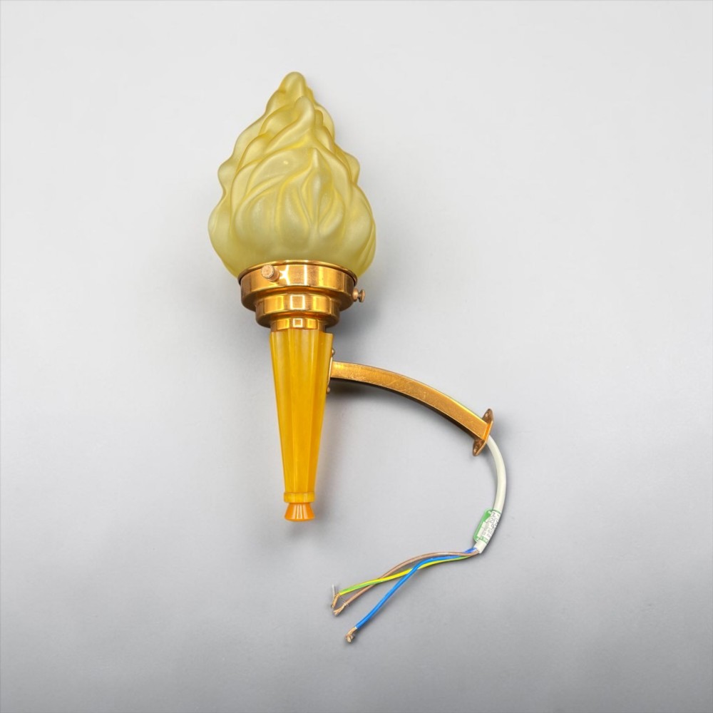 An Art Deco torch wall sconce featuring an amber flame-shaped moulded glass shade set on a yellow stepped stem with a brass mounting arm. View III