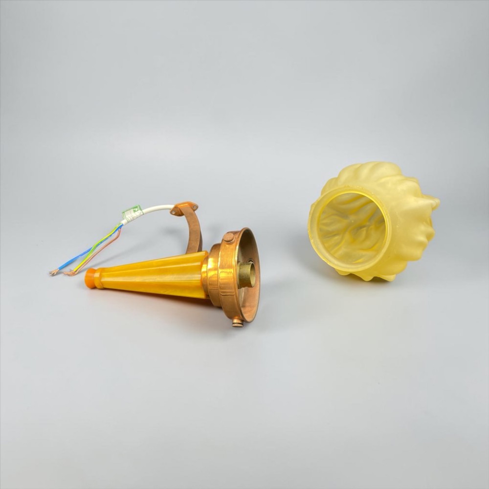 An Art Deco torch wall sconce featuring an amber flame-shaped moulded glass shade set on a yellow stepped stem with a brass mounting arm. View IV