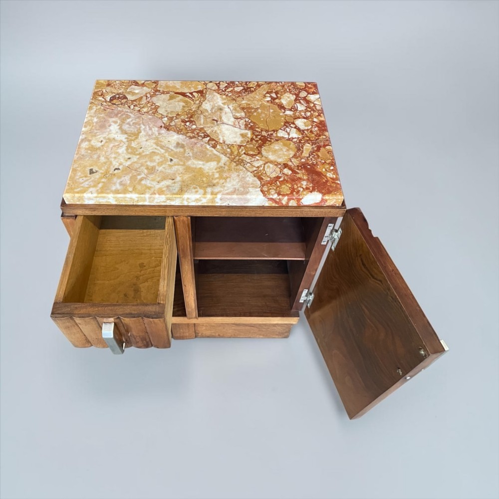 An Art Deco bedside cabinet crafted from polished brown walnut wood featuring a variegated reddish marble top surface and metal handles. View VI