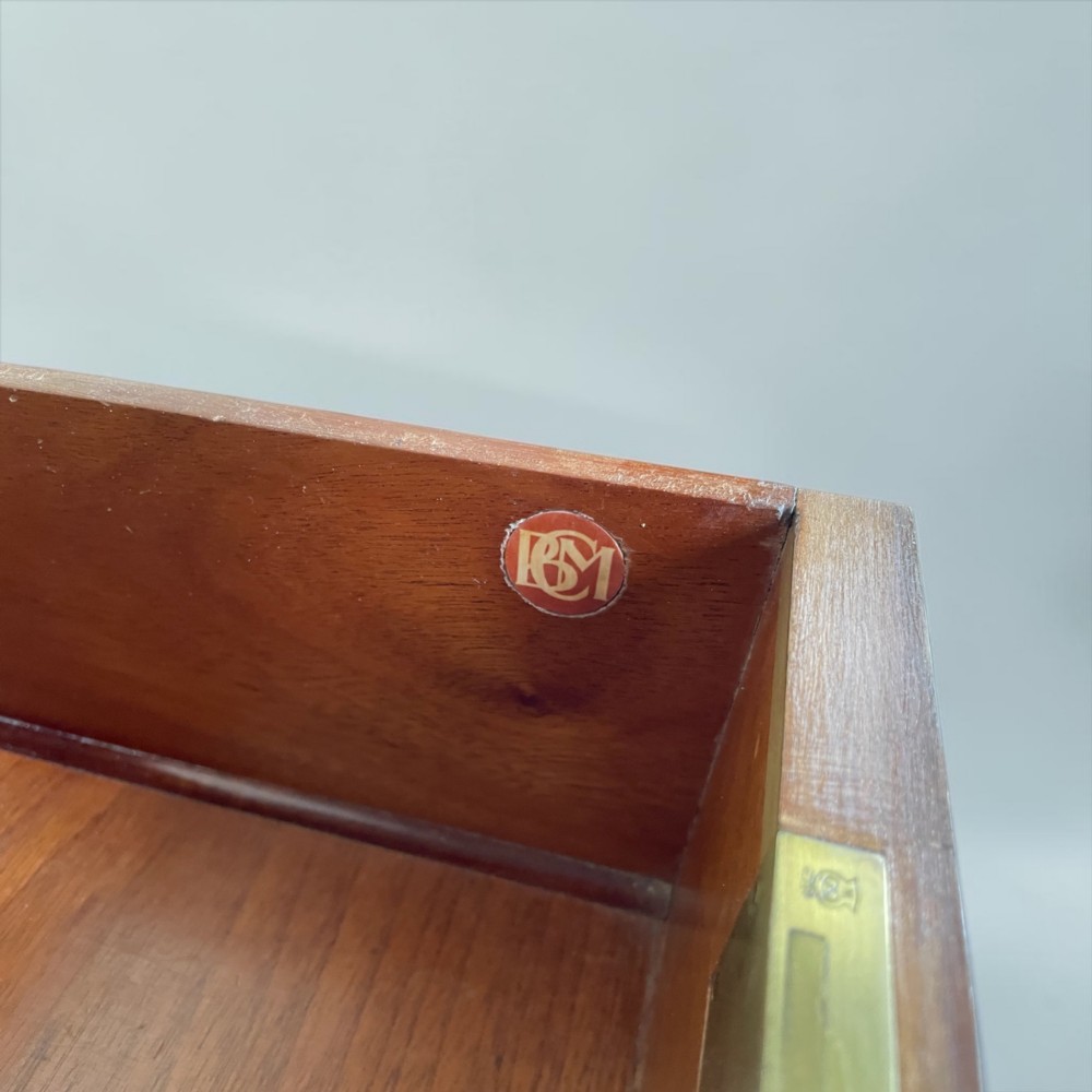 An Art Deco writing desk with geometric chevron parquetry drawer fronts, fine line inlay, and octagonal pulls on slender tapered legs. View VII