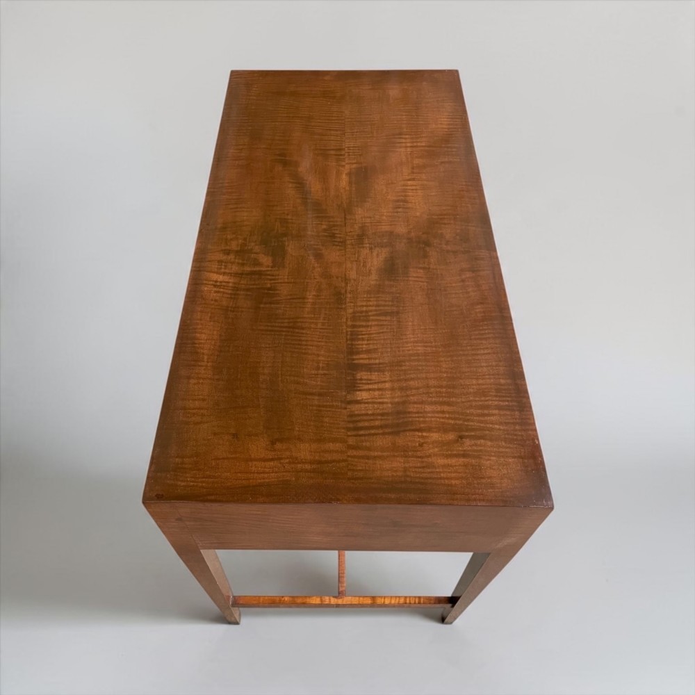An Art Deco writing desk with geometric chevron parquetry drawer fronts, fine line inlay, and octagonal pulls on slender tapered legs. View XI
