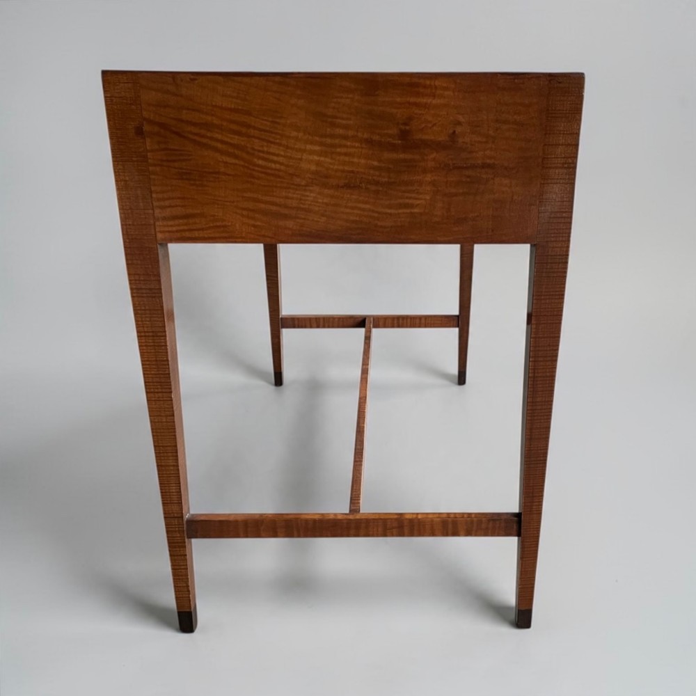 An Art Deco writing desk with geometric chevron parquetry drawer fronts, fine line inlay, and octagonal pulls on slender tapered legs. View XII